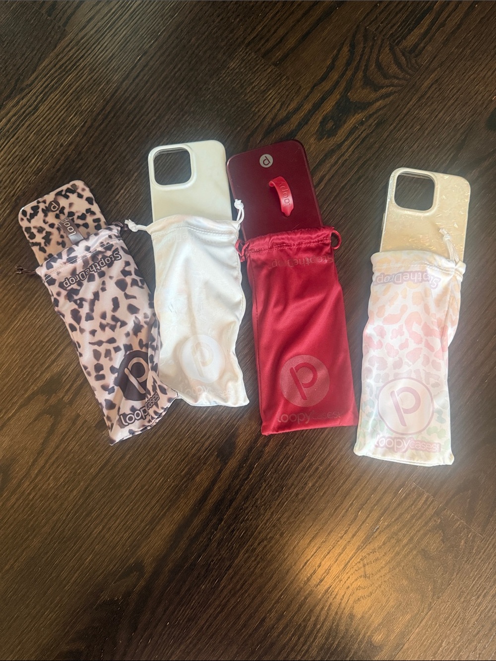 Loopy Case iPhone 15 pro Grip & Pouch Set in Red, 2 White, and tortoise.